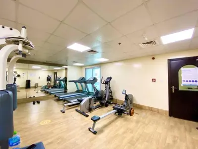 a gym with several treadmills and elliptical machines at Dubai Marina - Modern Designed - Gorgeous Studio- Close Metro Station in Dubai