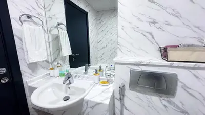 a white bathroom with a sink and a mirror at Dubai Marina - Modern Designed - Gorgeous Studio- Close Metro Station in Dubai