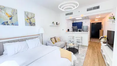 a bedroom with a bed and a living room at Dubai Marina - Modern Designed - Gorgeous Studio- Close Metro Station in Dubai