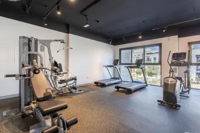 a gym with treadmills and machines in a room at Holiday Studio In JVC 0107, Dubai in Dubai