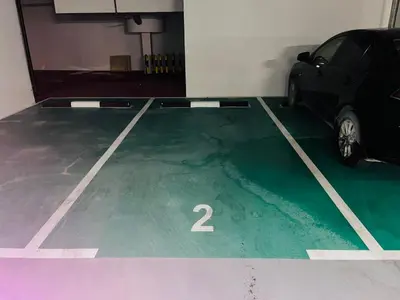 a car parked in a garage with the number two at Holiday Studio In JVC 0107, Dubai in Dubai