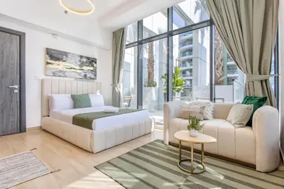 a living room with a couch and a bed at Holiday Studio In JVC 2302, Dubai in Dubai