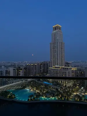 a view of a city at night with a tall building at Palace Dubai Creek Harbour Residences Skyline Apartment in Dubai
