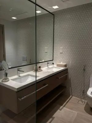 a bathroom with two sinks and a large mirror at Palace Dubai Creek Harbour Residences Skyline Apartment in Dubai