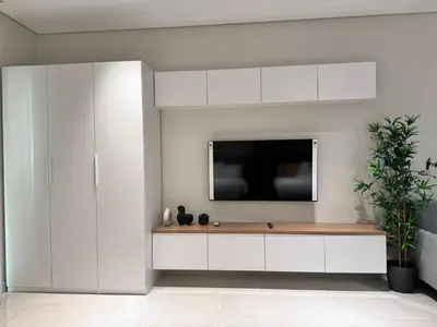 a living room with a tv on a wall at Cozy Spacious AG Tower Business Bay, Dubai in Dubai
