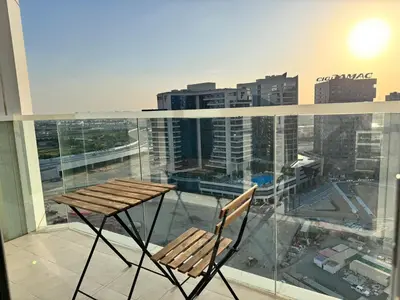 a chair on a balcony with a view of a city at Cozy Spacious AG Tower Business Bay, Dubai in Dubai