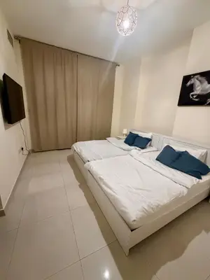 a bedroom with a large bed with blue pillows at Cozy Spacious AG Tower Business Bay, Dubai in Dubai