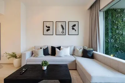 a living room with a couch and a table at Burj Khalifa View, 2 Balcony w Lounge, Dubai Mall Access, Gym, Infinity-Pool, Playground, BBQ, Family Friendly in Dubai