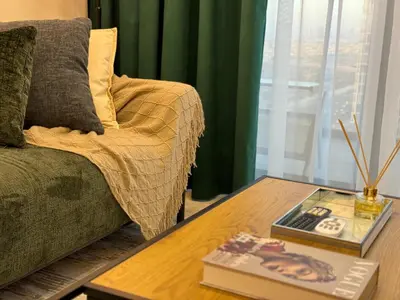 a living room with a couch and a coffee table at ASHRI HH, Luxurious Apt in JVC in Dubai