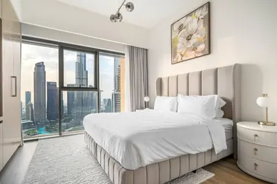a bedroom with a large bed and a large window at Mesmerizing view of Burj Khalifa in Dubai