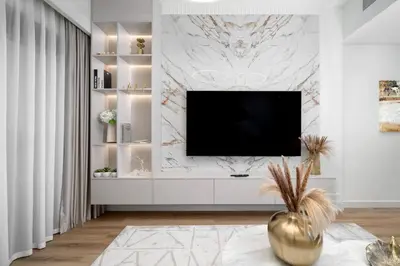 a living room with a television on a wall at Mesmerizing view of Burj Khalifa in Dubai