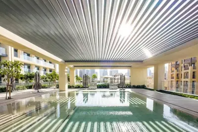 a large swimming pool in a building with a ceiling at Mesmerizing view of Burj Khalifa in Dubai