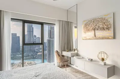 a bedroom with a large window with a tree on the wall at Mesmerizing view of Burj Khalifa in Dubai