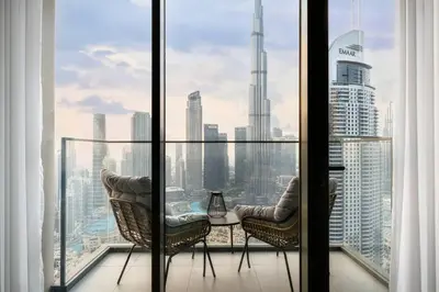 a balcony with two chairs and a view of the city at Mesmerizing view of Burj Khalifa in Dubai