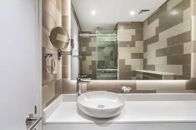 a bathroom with a white sink and a mirror at The Smart Concierge - Seven Palm in Dubai