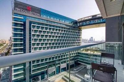 a tall building with a sign on the side of it at The Smart Concierge - Seven Palm in Dubai
