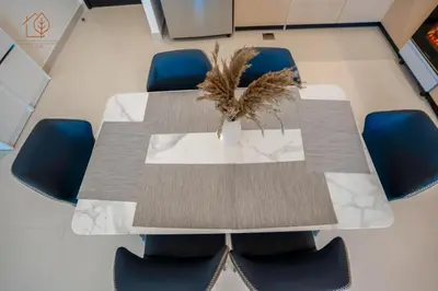 a conference room with a table and blue chairs at 3 Bedroom Family Apartment from High Floor Downtown Views 183BC-3 in Dubai