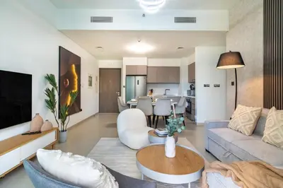 a living room with a couch and a table at Amazing 2BR Burj Kalifa View in Dubai