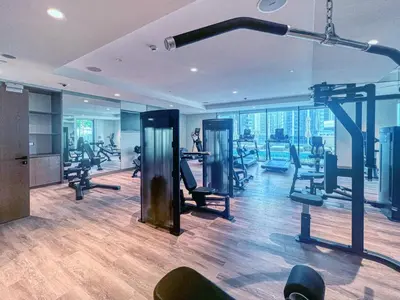 a gym with treadmills and ellipticals in a building at Amazing 2BR Burj Kalifa View in Dubai