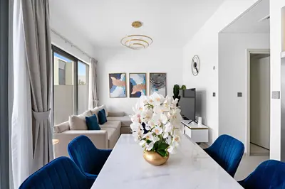 a living room with a table with a vase of flowers at Luxurious 6-Sleeper Villa with Large Outdoor Patio in Dubai