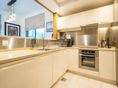 a kitchen with white cabinets and a sink at Spacious 1-Bed Apartment Next to Dubai Mall 157CL2-1 in Dubai