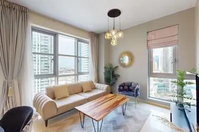 a living room with a couch and a table at Standpoint Tower A - Perfect One Bedroom in Dubai