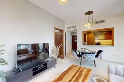 a living room with a television and a table at Standpoint Tower A - Perfect One Bedroom in Dubai