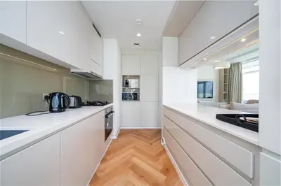 a kitchen with white cabinets and a counter top at Upgraded Banyan Tree 2 Bed in JLT in Dubai