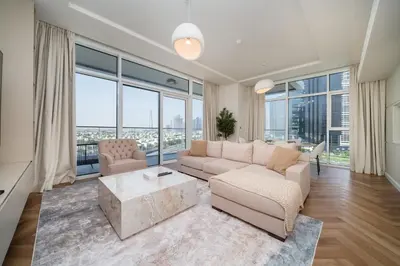 a living room with a couch and a table at Upgraded Banyan Tree 2 Bed in JLT in Dubai