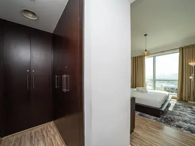 a room with a bedroom with a bed and a window at 2 Bedroom Delight in The Greens Dubai in Dubai