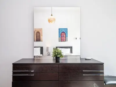 a bathroom with a vanity with a sink and a mirror at 2 Bedroom Delight in The Greens Dubai in Dubai