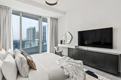 a bedroom with a large bed with a flat screen tv at The Smart Concierge - Stella Maris in Dubai