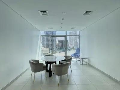 a dining room with a table and chairs and a window at The Smart Concierge - Stella Maris in Dubai