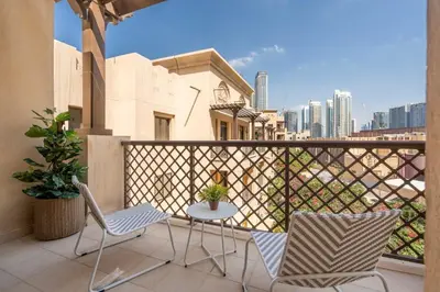 a balcony with two chairs and a table on a balcony at GuestReady - Groove Getaway in Downtown Dubai in Dubai