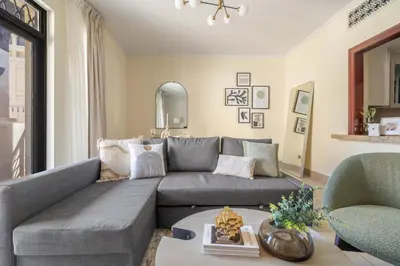 a living room with a gray couch and two chairs at GuestReady - Groove Getaway in Downtown Dubai in Dubai