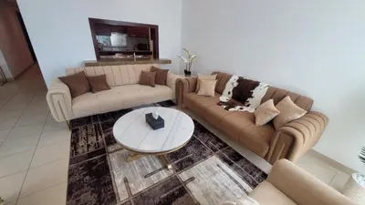 a living room with two couches and a table at Best Downtown Apartment in Dubai in Dubai
