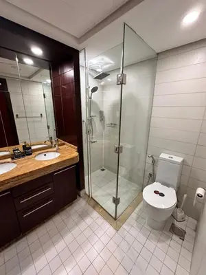 a bathroom with a glass shower and a toilet at Best Downtown Apartment in Dubai in Dubai