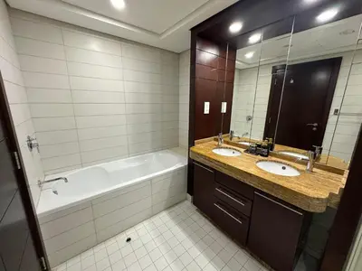 a bathroom with a tub and a sink and a bath tub at Best Downtown Apartment in Dubai in Dubai