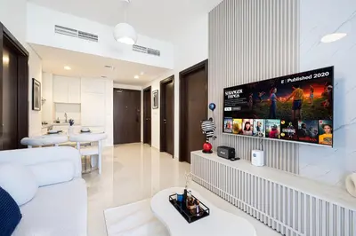 a living room with a flat screen tv on a wall at Modern Two Bedroom Apartment with Private Balcony By HSHOME - Downtown Dubai in Dubai