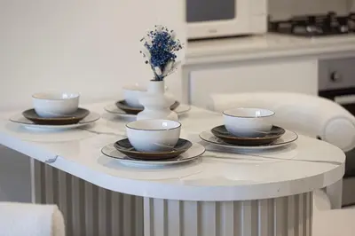 a table with four cups and saucers on it at Modern Two Bedroom Apartment with Private Balcony By HSHOME - Downtown Dubai in Dubai