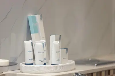 a group of white toothbrushes sitting on a shelf at Modern Two Bedroom Apartment with Private Balcony By HSHOME - Downtown Dubai in Dubai