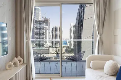 a room with a large window with a view of a city at Modern Two Bedroom Apartment with Private Balcony By HSHOME - Downtown Dubai in Dubai