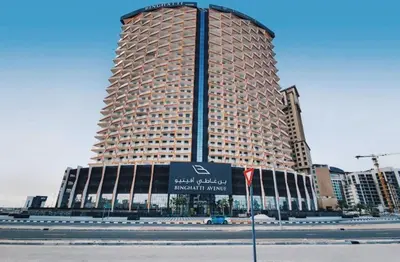 a large building with a sign in front of it at Luxury 1bedrom Binghatti Avenue in Dubai