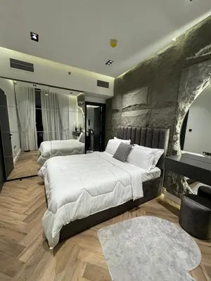 a bedroom with a large white bed and a piano at Luxury 1bedrom Binghatti Avenue in Dubai