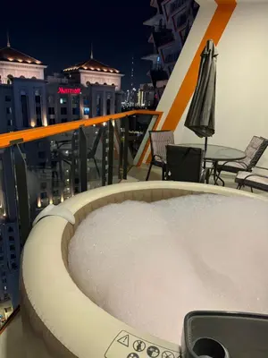 a hot tub on the balcony of a building at Luxury 1bedrom Binghatti Avenue in Dubai