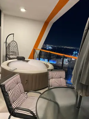 a room with a hot tub and two chairs at Luxury 1bedrom Binghatti Avenue in Dubai