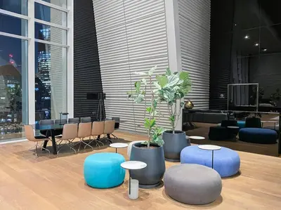 a lobby with a table and chairs and a potted plant at Burj Khalifa & Downtown Views - 3BR Family Retreat Near Dubai Mall in Dubai