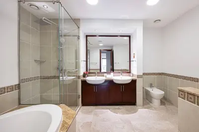 a bathroom with two sinks and a shower at Fairmont North 2BR 2 Balconies Sea View in Dubai
