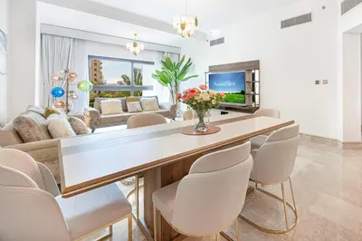 a living room with a dining table and chairs at Fairmont North 2BR 2 Balconies Sea View in Dubai