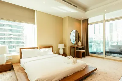 a bedroom with a large bed and a large window at Stunning 2BR with Captivating Marina View - 17AB06 in Dubai